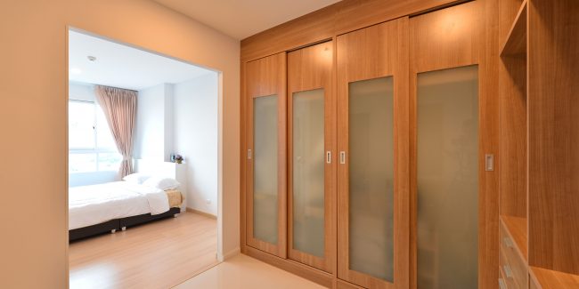 wooden carbinets in dressing room in modern home, interior design